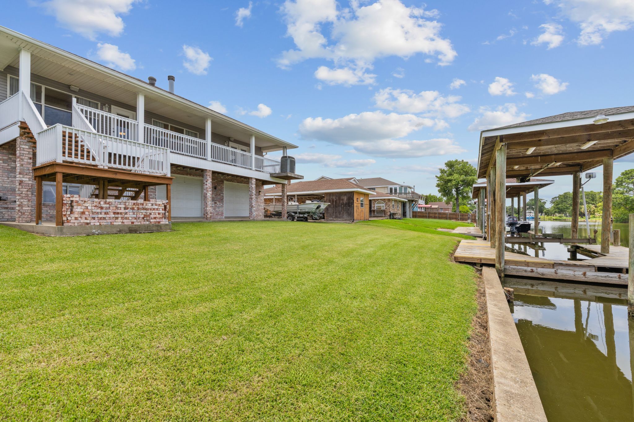 The home seen across the lawn with the canal beyond