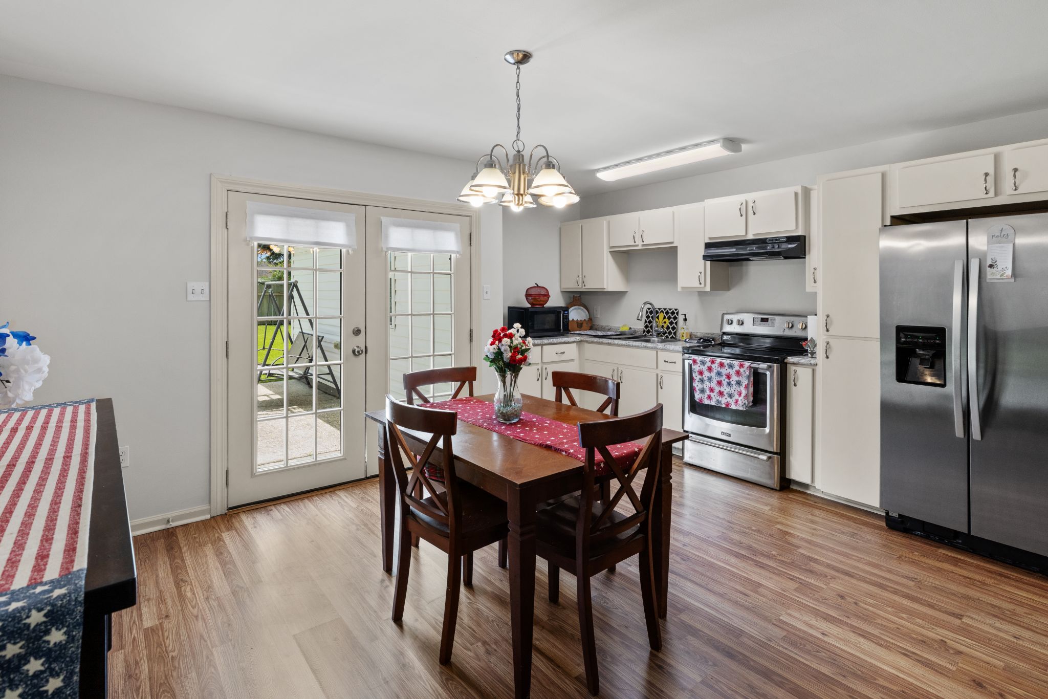 Kitchen and dining with French doors to the backyard